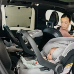 Child in car seat with Easy-Fit Sunshade attached to car window