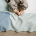 Baby laying on Blue Knit Blanket