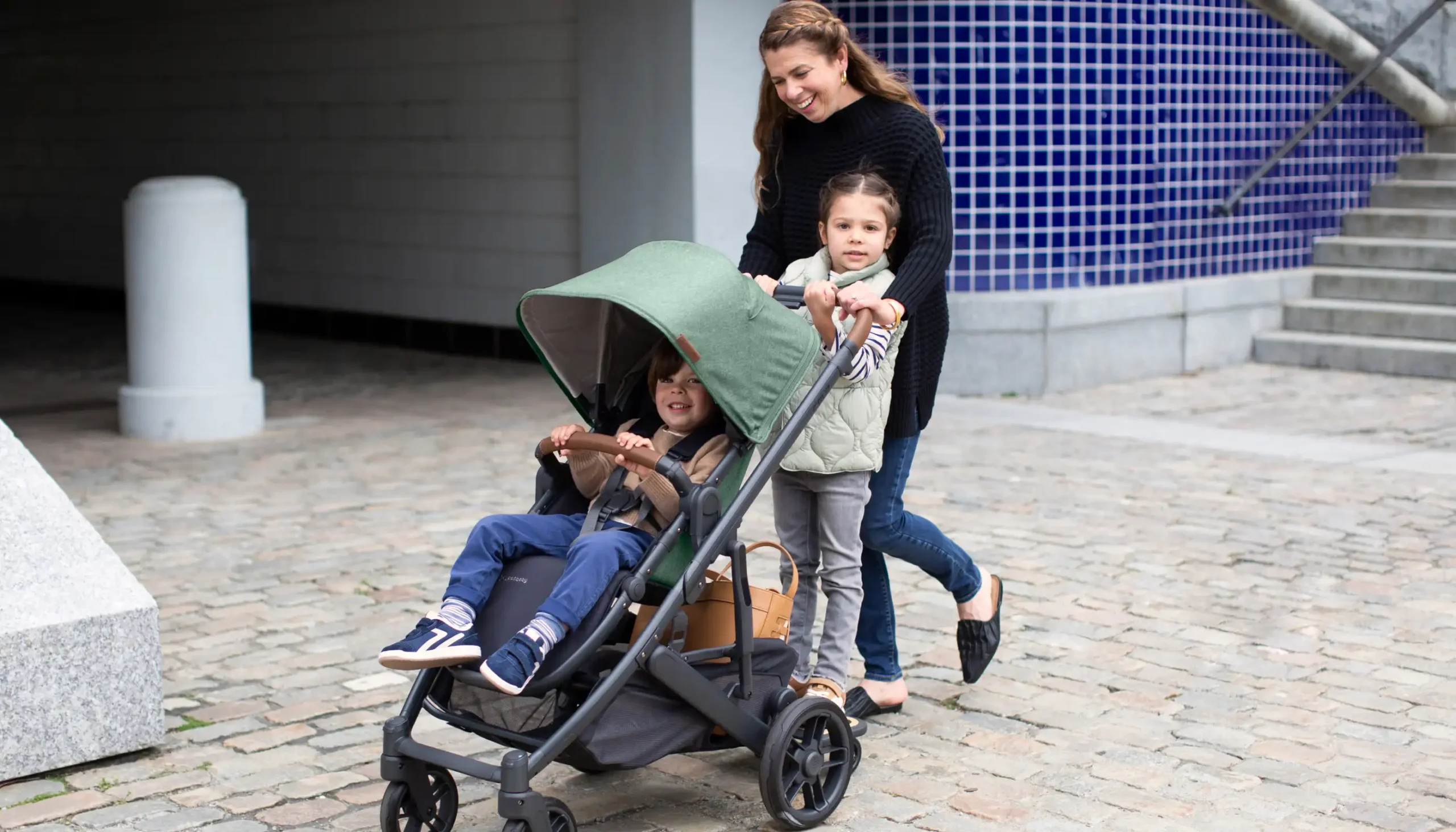 Parent pushing children on PiggyBack and Toddler Seat in Cruz V2 Stroller