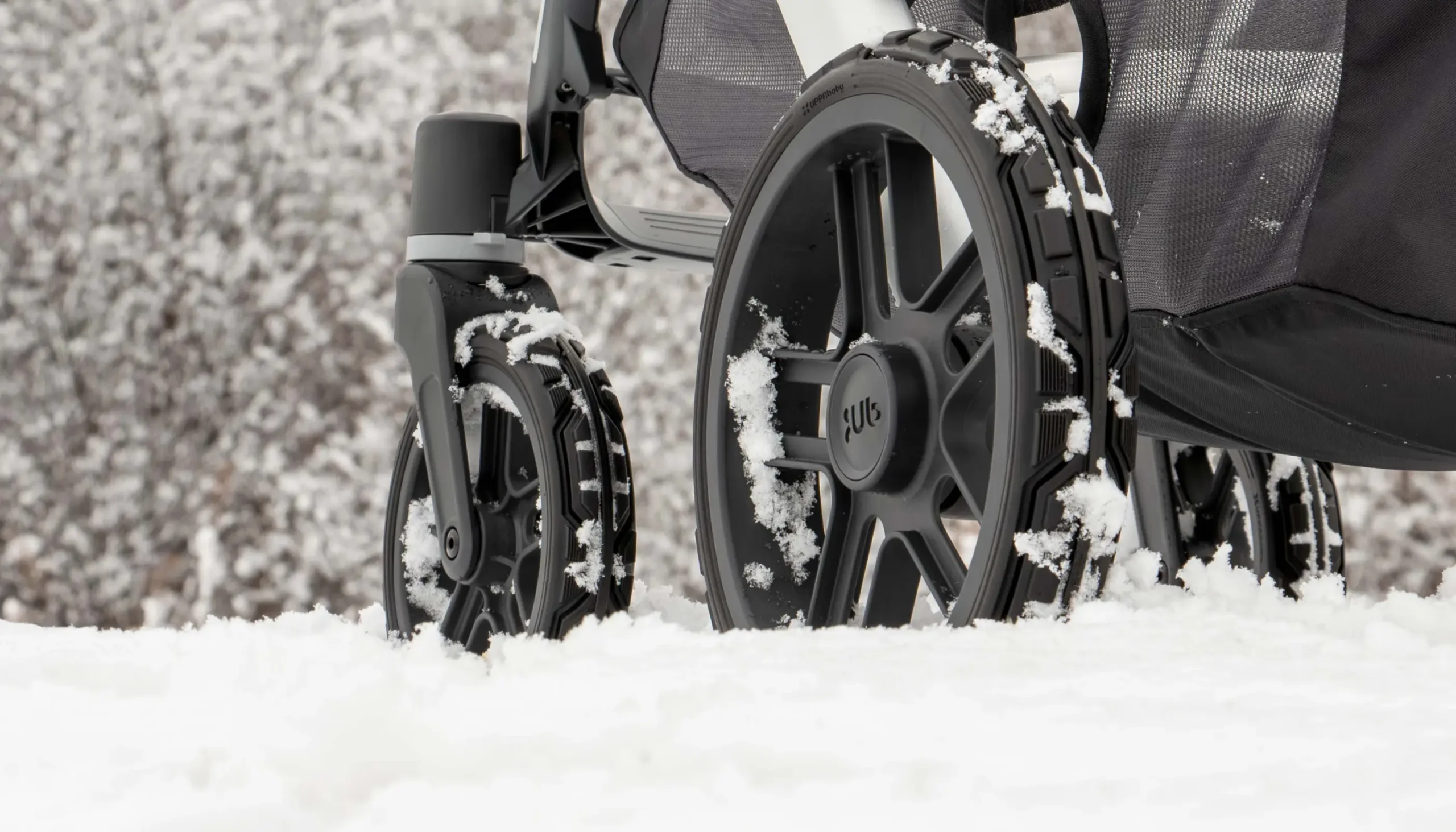 Stroller with All Terrain Wheels pushing through snow