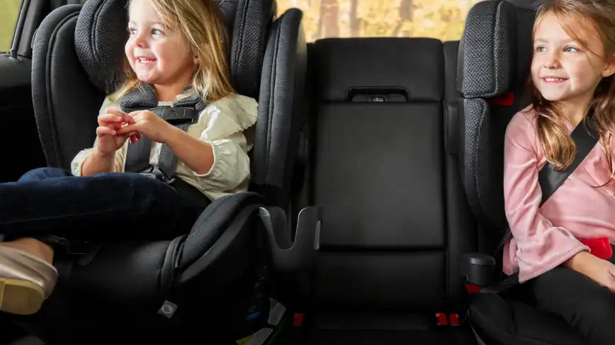 Child sitting in Knox with Cup Holder attached