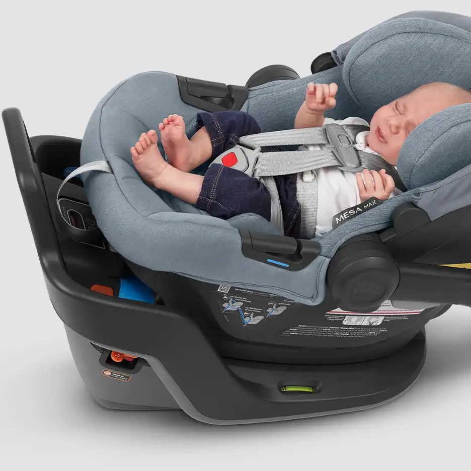 Infant securely in car seat with harness straps snug over the infant’s thigh