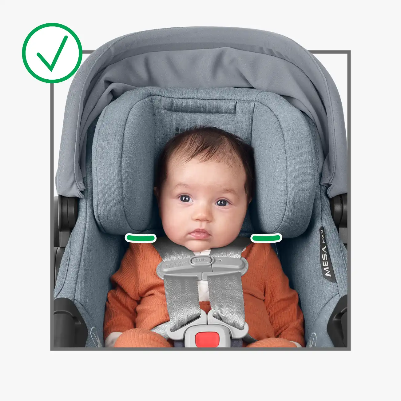 Infant in car seat showcasing correct headrest and harness position. Harness straps are placed at or slightly below her shoulders, the top of the baby's head is positioned more than 1″ from the top of the headrest structure, and the bottom of the headrest ears appear to be touching the child’s shoulders (lines drawn on top of image to highlight where bottom headrest ears lay)