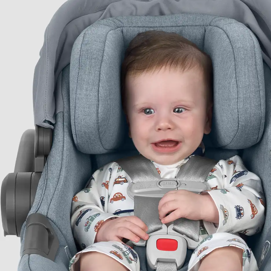 Infant sitting in infant car seat with the proper fit and no harness pads.